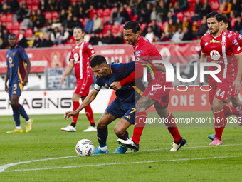 Lorenzo Pellegrini and Armando Izzo are in action during the Serie A match between AC Monza and AS Roma at U-Power Stadium in Monza, Italy,...