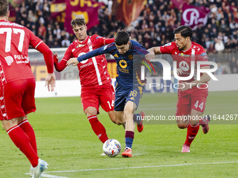 Matias Soule, Daniel Maldini, and Andrea Carboni are in action during the Serie A match between AC Monza and AS Roma at U-Power Stadium in M...