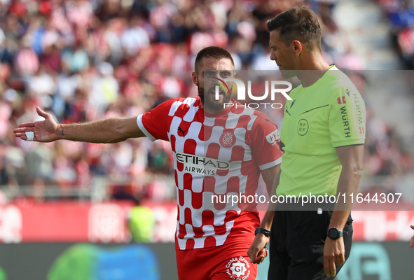 The referee Juan Luis Pulido Santana and David Lopez are present during the match between Girona FC and Athletic Club, corresponding to week...