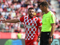 The referee Juan Luis Pulido Santana and David Lopez are present during the match between Girona FC and Athletic Club, corresponding to week...