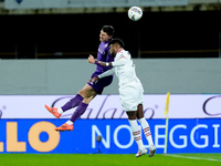 Emerson Royal of AC Milan and Moise Kean of ACF Fiorentina jump for the ball during the Serie A Enilive match between ACF Fiorentina and AC...