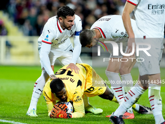 Mike Maignan of AC Milan celebrates with Alvaro Morata of AC Milan and Theo Hernandez of AC Milan after saving the penalty kick during the S...