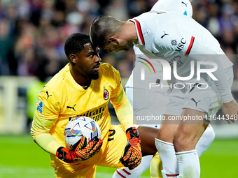 Mike Maignan of AC Milan celebrates with Alvaro Morata after saving the penalty kick during the Serie A Enilive match between ACF Fiorentina...