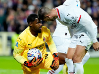 Mike Maignan of AC Milan celebrates with Alvaro Morata after saving the penalty kick during the Serie A Enilive match between ACF Fiorentina...