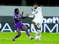 Moise Kean of ACF Fiorentina and Emerson Royal of AC Milan compete for the ball during the Serie A Enilive match between ACF Fiorentina and...