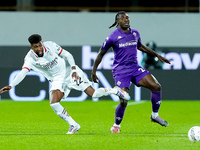 Moise Kean of ACF Fiorentina and Emerson Royal of AC Milan compete for the ball during the Serie A Enilive match between ACF Fiorentina and...