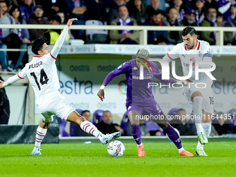 Dodo of ACF Fiorentina is challenged by Tijjani Reijnders of AC Milan and Theo Hernandez of AC Milan during the Serie A Enilive match betwee...