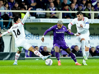 Dodo of ACF Fiorentina is challenged by Tijjani Reijnders of AC Milan and Theo Hernandez of AC Milan during the Serie A Enilive match betwee...