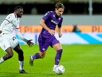 Youssouf Fofana of AC Milan and Edoardo Bove of ACF Fiorentina compete for the ball during the Serie A Enilive match between ACF Fiorentina...