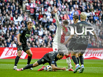 FC Groningen defender Marco Rente and AFC Ajax Amsterdam forward Mika Godts participate in the match between Ajax and Groningen at the Johan...