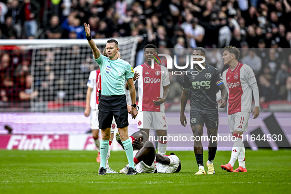 Referee Allard Lindhout, AFC Ajax Amsterdam defender Jorrel Hato, AFC Ajax Amsterdam forward Brian Brobbey, and AFC Ajax Amsterdam forward M...