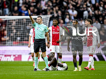 Referee Allard Lindhout, AFC Ajax Amsterdam defender Jorrel Hato, AFC Ajax Amsterdam forward Brian Brobbey, and AFC Ajax Amsterdam forward M...