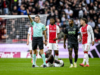 Referee Allard Lindhout, AFC Ajax Amsterdam defender Jorrel Hato, AFC Ajax Amsterdam forward Brian Brobbey, and AFC Ajax Amsterdam forward M...