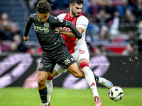 FC Groningen forward Thom van Bergen and AFC Ajax Amsterdam defender Josip Sutalo play during the match between Ajax and Groningen at the Jo...