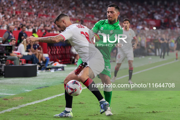 Jesus Joaquin Fernandez ''Suso'' of Sevilla FC competes for the ball with Chimy Avila of Real Betis during the La Liga EA Sports match betwe...