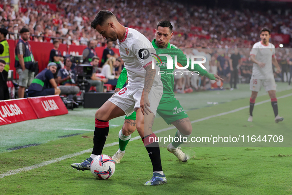 Jesus Joaquin Fernandez ''Suso'' of Sevilla FC competes for the ball with Chimy Avila of Real Betis during the La Liga EA Sports match betwe...