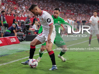 Jesus Joaquin Fernandez ''Suso'' of Sevilla FC competes for the ball with Chimy Avila of Real Betis during the La Liga EA Sports match betwe...