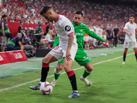 Jesus Joaquin Fernandez ''Suso'' of Sevilla FC competes for the ball with Chimy Avila of Real Betis during the La Liga EA Sports match betwe...