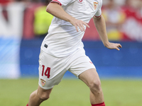 Peque Fernandez of Sevilla FC runs with the ball during the La Liga EA Sports match between Sevilla FC and Real Betis at Sanchez Pizjuan in...