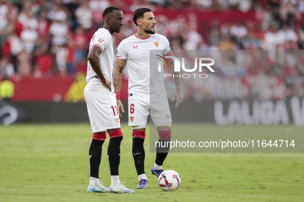 Nemanja Gudelj of Sevilla FC and Dodi Lukebakio of Sevilla FC participate in the La Liga EA Sports match between Sevilla FC and Real Betis a...