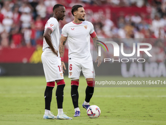 Nemanja Gudelj of Sevilla FC and Dodi Lukebakio of Sevilla FC participate in the La Liga EA Sports match between Sevilla FC and Real Betis a...