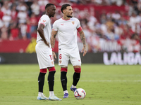 Nemanja Gudelj of Sevilla FC and Dodi Lukebakio of Sevilla FC participate in the La Liga EA Sports match between Sevilla FC and Real Betis a...