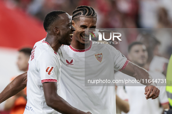 Loic Bade of Sevilla FC and Dodi Lukebakio of Sevilla FC celebrate winning during the La Liga EA Sports match between Sevilla FC and Real Be...