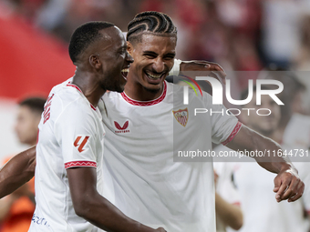 Loic Bade of Sevilla FC and Dodi Lukebakio of Sevilla FC celebrate winning during the La Liga EA Sports match between Sevilla FC and Real Be...