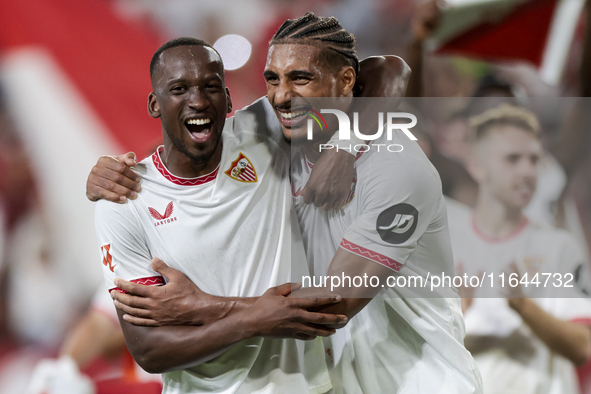 Dodi Lukebakio and Loic Bade of Sevilla FC celebrate winning during the La Liga EA Sports match between Sevilla FC and Real Betis at Sanchez...