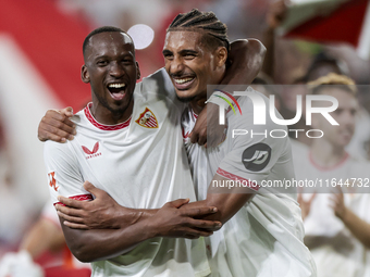 Dodi Lukebakio and Loic Bade of Sevilla FC celebrate winning during the La Liga EA Sports match between Sevilla FC and Real Betis at Sanchez...