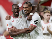 Dodi Lukebakio and Loic Bade of Sevilla FC celebrate winning during the La Liga EA Sports match between Sevilla FC and Real Betis at Sanchez...