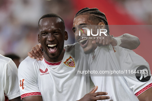 Loic Bade of Sevilla FC and Dodi Lukebakio of Sevilla FC celebrate winning during the La Liga EA Sports match between Sevilla FC and Real Be...