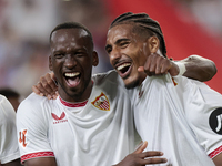 Loic Bade of Sevilla FC and Dodi Lukebakio of Sevilla FC celebrate winning during the La Liga EA Sports match between Sevilla FC and Real Be...