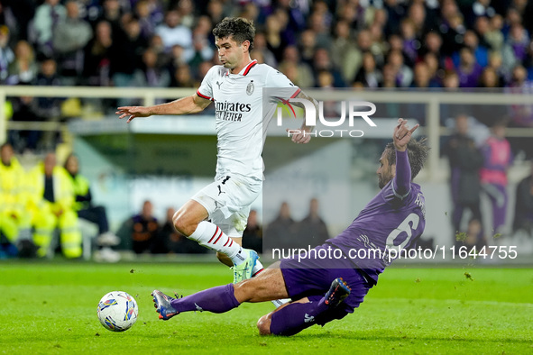 Luca Ranieri of ACF Fiorentina and Christian Pulisic of AC Milan compete for the ball during the Serie A Enilive match between ACF Fiorentin...