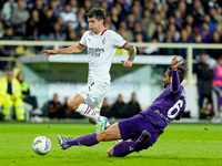 Luca Ranieri of ACF Fiorentina and Christian Pulisic of AC Milan compete for the ball during the Serie A Enilive match between ACF Fiorentin...