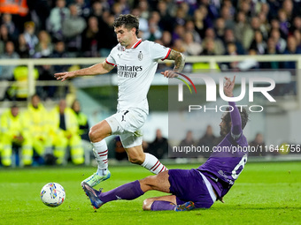 Luca Ranieri of ACF Fiorentina and Christian Pulisic of AC Milan compete for the ball during the Serie A Enilive match between ACF Fiorentin...