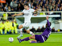 Luca Ranieri of ACF Fiorentina and Christian Pulisic of AC Milan compete for the ball during the Serie A Enilive match between ACF Fiorentin...