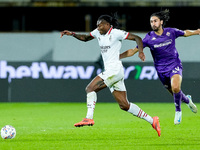 Yacine Adly of ACF Fiorentina and Rafael Leao of AC Milan compete for the ball during the Serie A Enilive match between ACF Fiorentina and A...