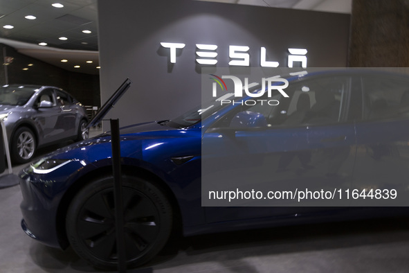 A Tesla Model 3 car is seen inside a Tesla dealer in Lisbon, Portugal, on October 6, 2024. Tesla's third-quarter 2024 results show strong ve...