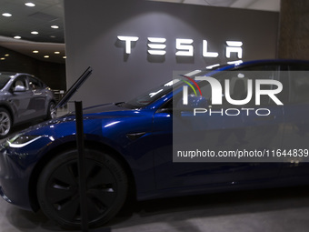 A Tesla Model 3 car is seen inside a Tesla dealer in Lisbon, Portugal, on October 6, 2024. Tesla's third-quarter 2024 results show strong ve...