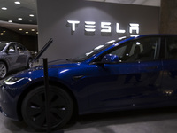 A Tesla Model 3 car is seen inside a Tesla dealer in Lisbon, Portugal, on October 6, 2024. Tesla's third-quarter 2024 results show strong ve...