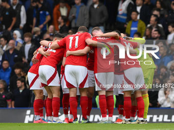 Forest players form a huddle before the Premier League match between Chelsea and Nottingham Forest at Stamford Bridge in London, England, on...