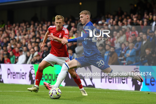 Cole Palmer of Chelsea lines up a cross under pressure from James Ward-Prowse of Nottingham Forest during the Premier League match between C...