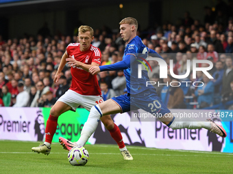 Cole Palmer of Chelsea lines up a cross under pressure from James Ward-Prowse of Nottingham Forest during the Premier League match between C...