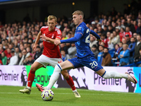 Cole Palmer of Chelsea lines up a cross under pressure from James Ward-Prowse of Nottingham Forest during the Premier League match between C...