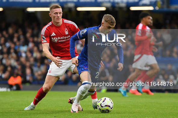 Cole Palmer of Chelsea is under pressure from Elliott Anderson of Nottingham Forest during the Premier League match between Chelsea and Nott...