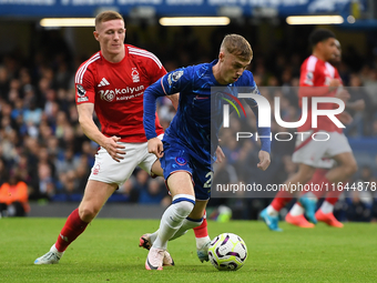 Cole Palmer of Chelsea is under pressure from Elliott Anderson of Nottingham Forest during the Premier League match between Chelsea and Nott...