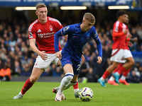 Cole Palmer of Chelsea is under pressure from Elliott Anderson of Nottingham Forest during the Premier League match between Chelsea and Nott...