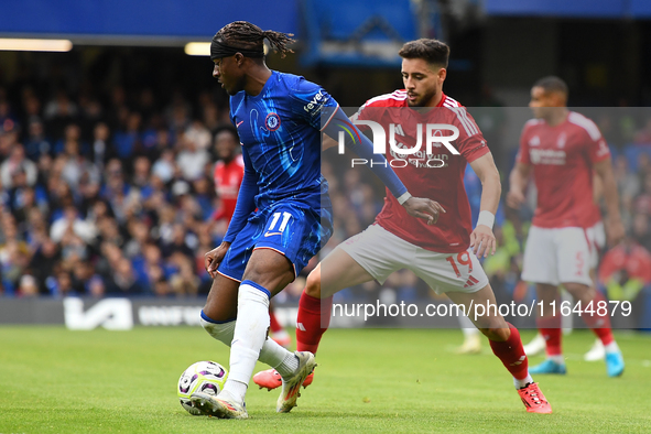 Noni Madueke of Chelsea is under pressure from Alex Moreno of Nottingham Forest during the Premier League match between Chelsea and Nottingh...