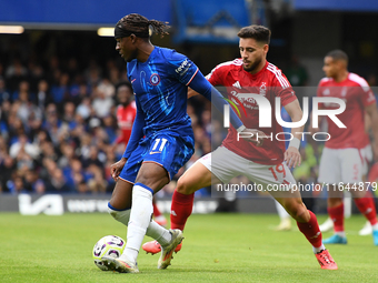 Noni Madueke of Chelsea is under pressure from Alex Moreno of Nottingham Forest during the Premier League match between Chelsea and Nottingh...